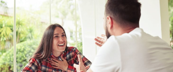 A male NDIS participant sitting in a bright room, talking to his Psychosocial Recovery Coach